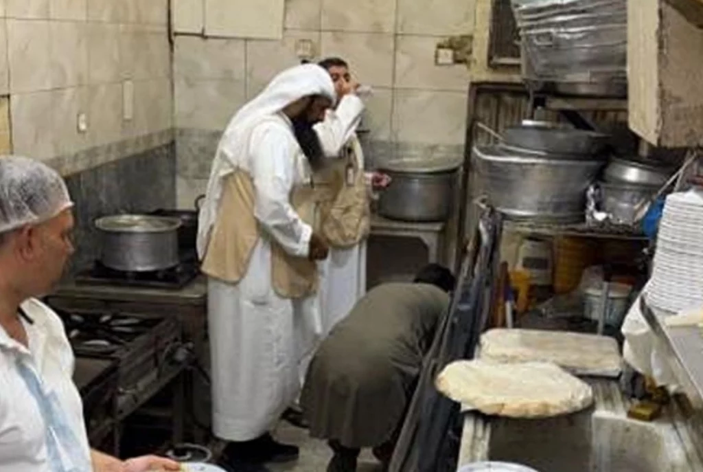 Food inspectors conducting health and safety inspections at food establishments in Kuwait during a PAFN campaign.