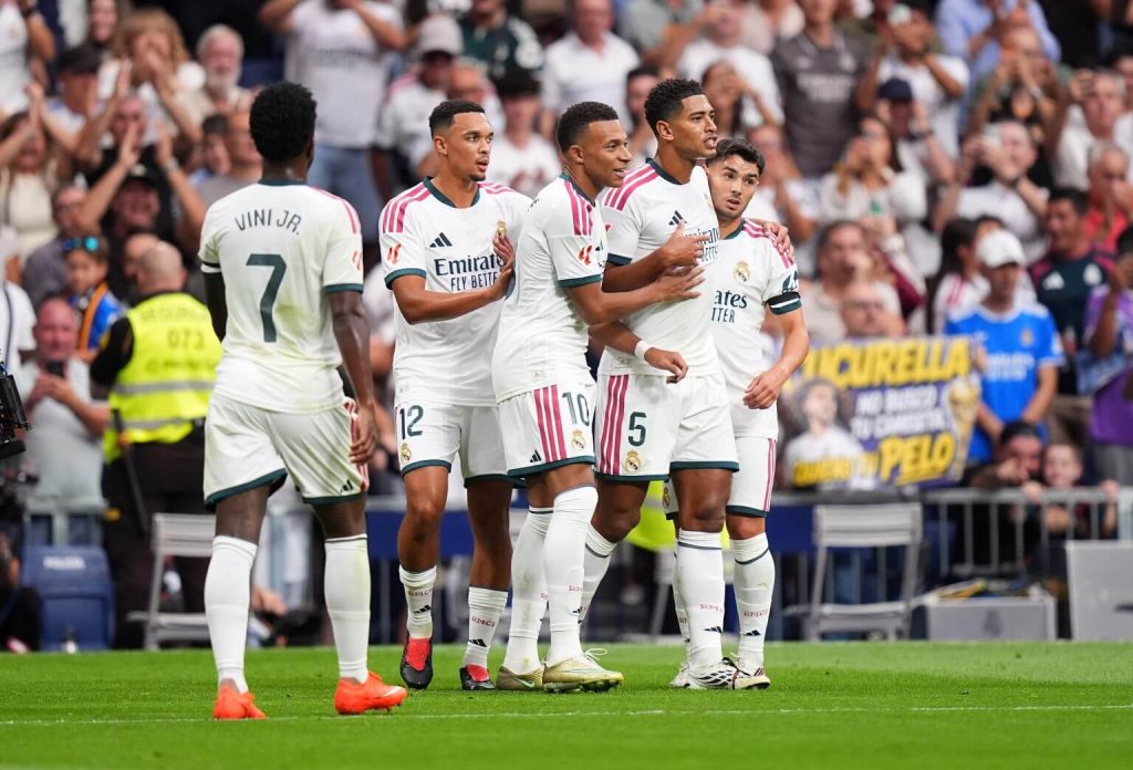 Real Madrid players celebrating a goal against Malaga at Santiago Bernabeu