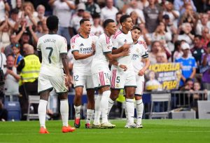 Real Madrid players celebrating a goal against Malaga at Santiago Bernabeu