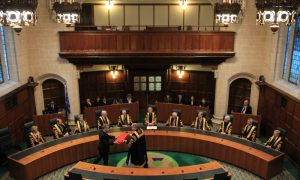 Supreme Court gavel and law books representing judicial practice requirement ruling