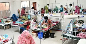 Sick child receiving oxygen treatment during Bangladesh measles outbreak in a crowded hospital ward